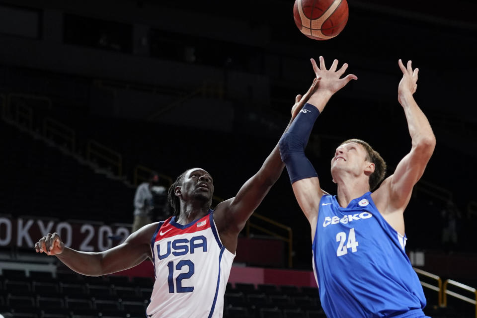 United States's Jrue Holiday (12) fights for a rebound with the Czech Republic's Jan Vesely (24) during a men's basketball preliminary round game at the 2020 Summer Olympics, Saturday, July 31, 2021, in Saitama, Japan. (AP Photo/Charlie Neibergall)