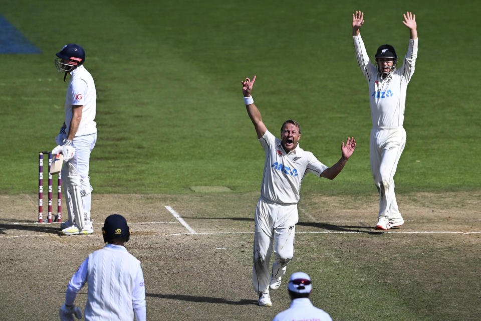 New Zealand's Neil Wagner, center, celebrates the wicket of England's James Anderson, left, for the win by 1 run on day 5 of their cricket test match in Wellington, New Zealand, Tuesday, Feb 28, 2023. (Andrew Cornaga/Photosport via AP)