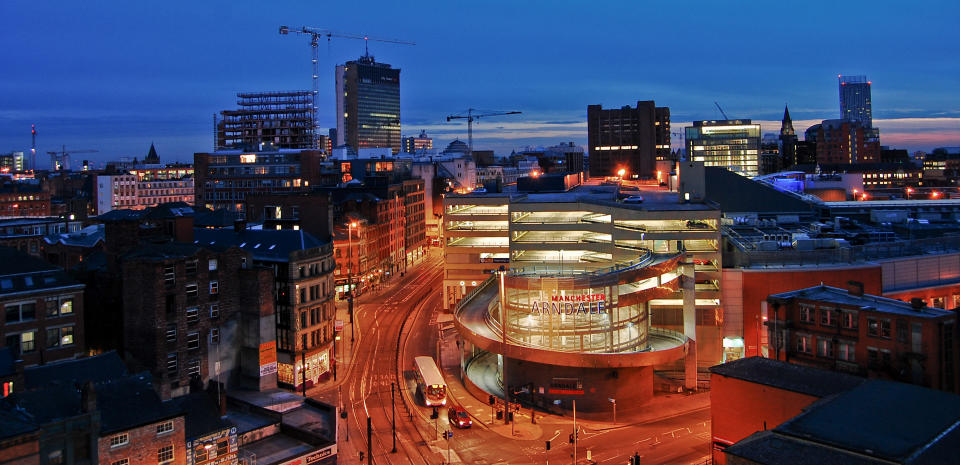 An urban evening view of Manchester in Lancashire, England. This image was taken from the top of a multistorey car park close to the city centre.