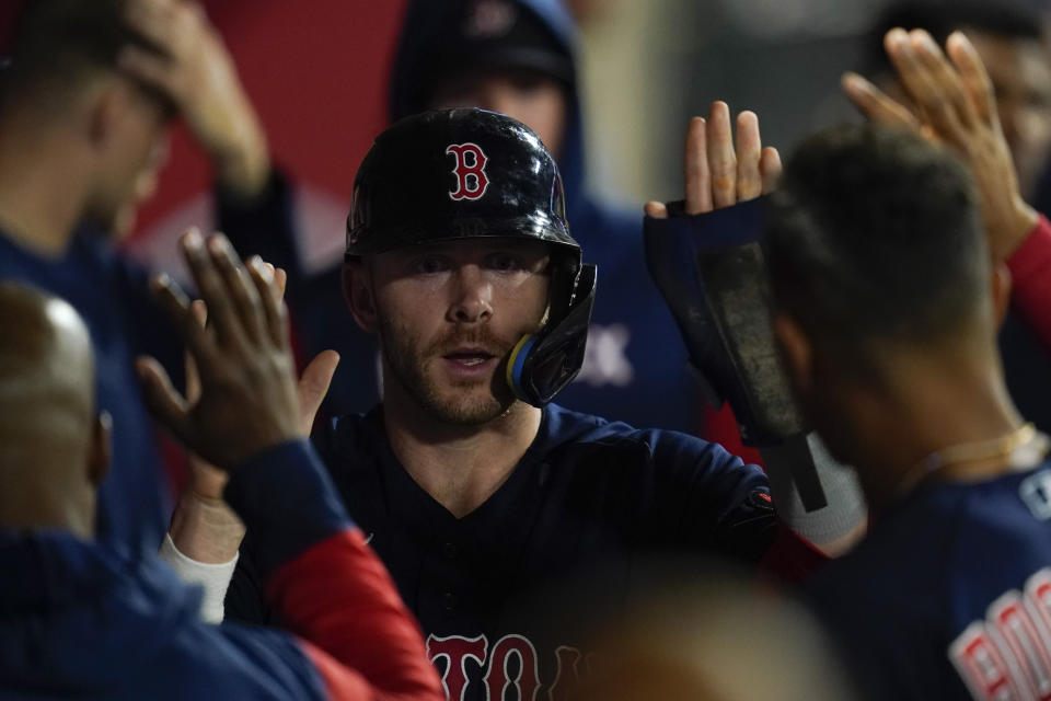 Boston Red Sox's Trevor Story celebrates in the dugout after scoring off of a single hit by Christian Vazquez during the tenth inning of a baseball game in Anaheim, Calif., Tuesday, June 7, 2022. (AP Photo/Ashley Landis)