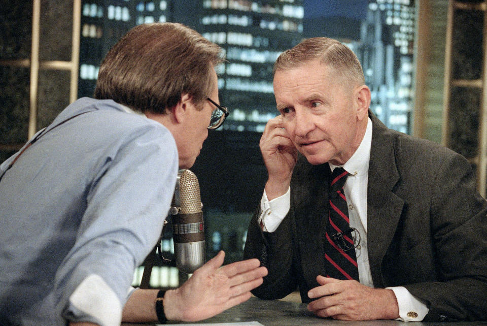 FILE - In this July 18, 1992 file photo, Larry King, left, talks with Texas billionaire Ross Perot during a commercial break in the live broadcast of CNN's 'Larry King Live' in New York. King, who interviewed presidents, movie stars and ordinary Joes during a half-century in broadcasting, has died at age 87. Ora Media, the studio and network he co-founded, tweeted that King died Saturday, Jan. 23, 2021 morning at Cedars-Sinai Medical Center in Los Angeles. (AP Photo/Alex Brandon, File)