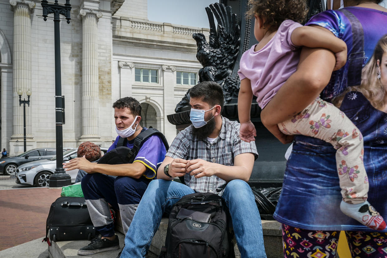 Migrants who were transported on a bus from Texas are seen outside of Union Station in Washington, DC, on April 13, 2022. (Craig Hudson for The Washington Post via Getty Images)