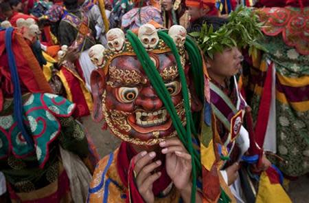 A Bhutanese man adjusts his mask before taking part in a rehearsal ceremony ahead of the royal wedding of King Jigme Khesar Namgyel Wangchuck in Bhutan's capital Thimphu on October 11, 2011. The Bhutanese king is scheduled to wed his fiancee Jetsun Pema over a three-day ceremony starting in the ancient capital Punakha on October 13. REUTERS/Adrees Latif