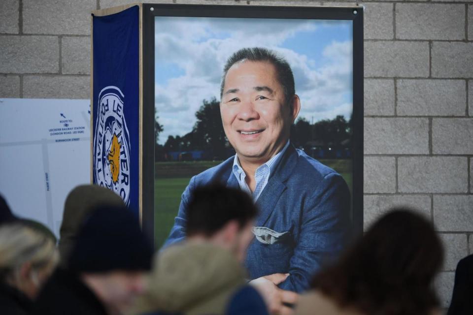 People pause at a portrait of Leicester City Football Club's Thai chairman Vichai Srivaddhanaprabha (AFP/Getty Images)