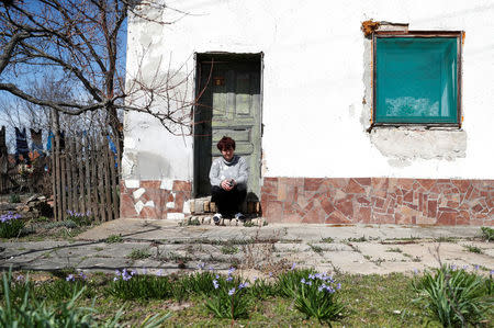 Timea Komaromi sits in front of her house in the village of Bacsszentgyorgy, Hungary, April 3, 2018. Previous waves of migration, mostly from the former Yugoslavia and Kosovo, caused her no fear. "I even fed goulash to some of those families. These people now are different. They are not Christian," said Komaromi. REUTERS/Bernadett Szabo