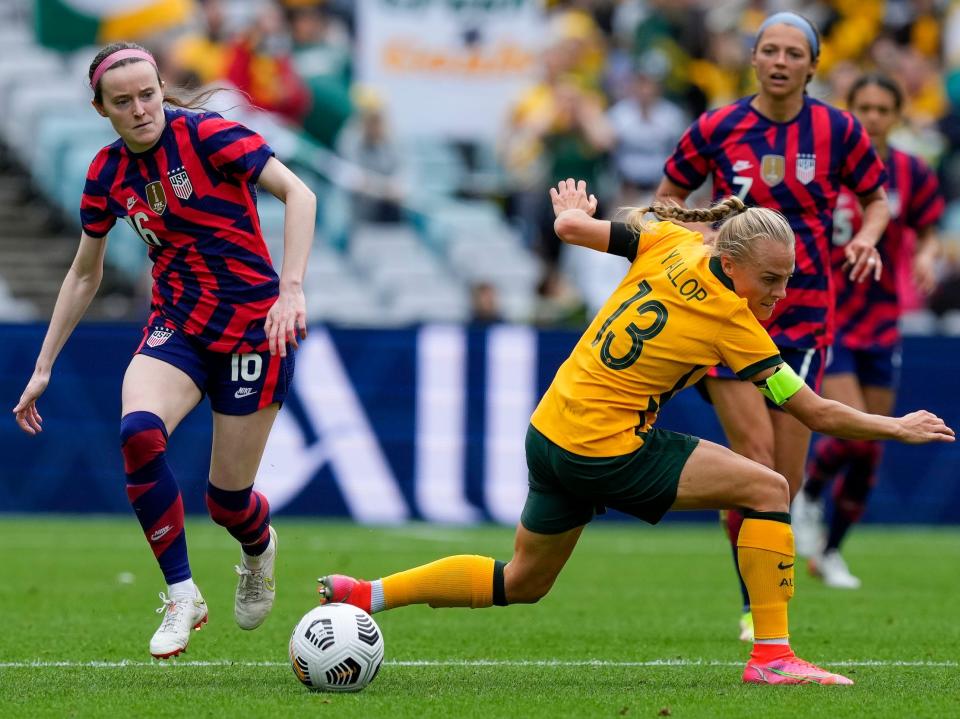 Rose Lavelle dribbles past a defender during a USWNT game against Australia's Matildas.