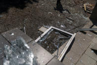 A worker cleans up after an early morning rocket attack hit the Kramatorsk College of Technologies and Design in Kramatorsk, Donetsk region, eastern Ukraine, Friday, Aug. 19, 2022. Russia continued to shell towns and villages in Ukraine's embattled eastern Donetsk region, according to regional authorities, where Russian forces are pushing to overtake areas still held by Ukraine. (AP Photo/David Goldman)