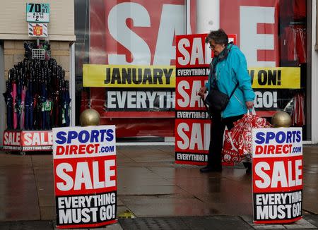 A pedestrian walks past a branch of Sports Direct in Liverpool northern England December 15, 2011. REUTERS/Phil Noble