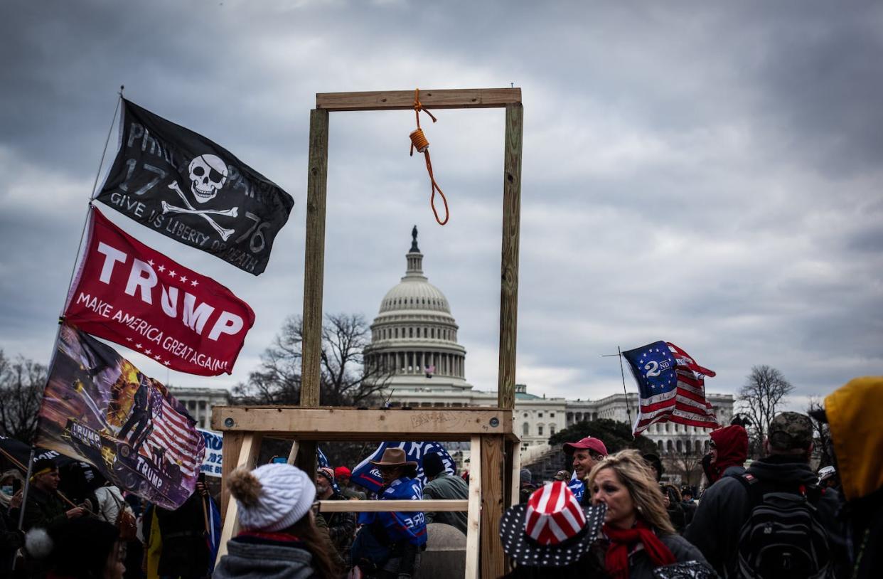 <span class="caption">Crowds carrying hate symbols as they stormed the U.S Capitol on Jan. 6 in Washington, D.C.</span> <span class="attribution"><a class="link " href="https://www.gettyimages.com/detail/news-photo/trump-supporters-near-the-u-s-capitol-on-january-06-2021-in-news-photo/1230476983?adppopup=true" rel="nofollow noopener" target="_blank" data-ylk="slk:Shay Horse/NurPhoto via Getty Images;elm:context_link;itc:0;sec:content-canvas">Shay Horse/NurPhoto via Getty Images</a></span>