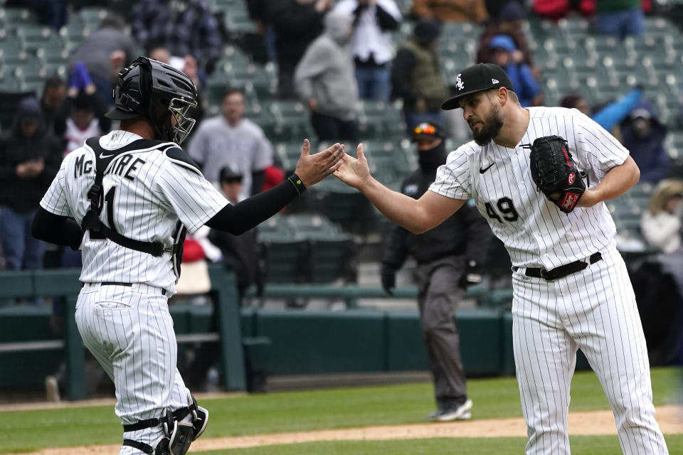 Chicago White Sox catcher Reese McGuire, left, and relief pitcher Kendall Graveman celebrate the team's 7-3 win over the Kansas City Royals after a baseball game Wednesday, April 27, 2022, in Chicago. (AP Photo/Charles Rex Arbogast)