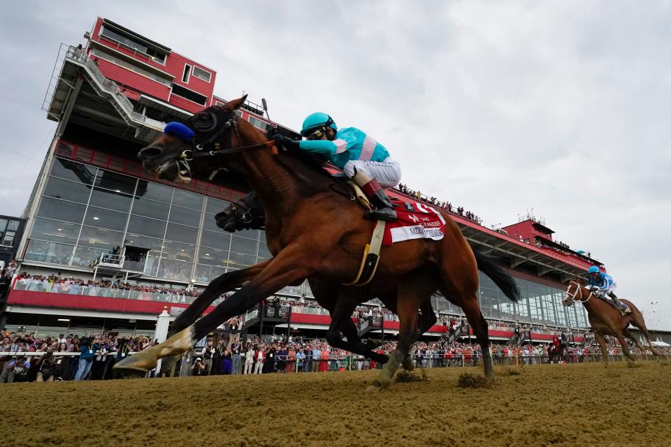 National Treasure, ridden by jockey John Velazquez, edges Blazing Sevens to win the Preakness Stakes on Saturday in Baltimore.