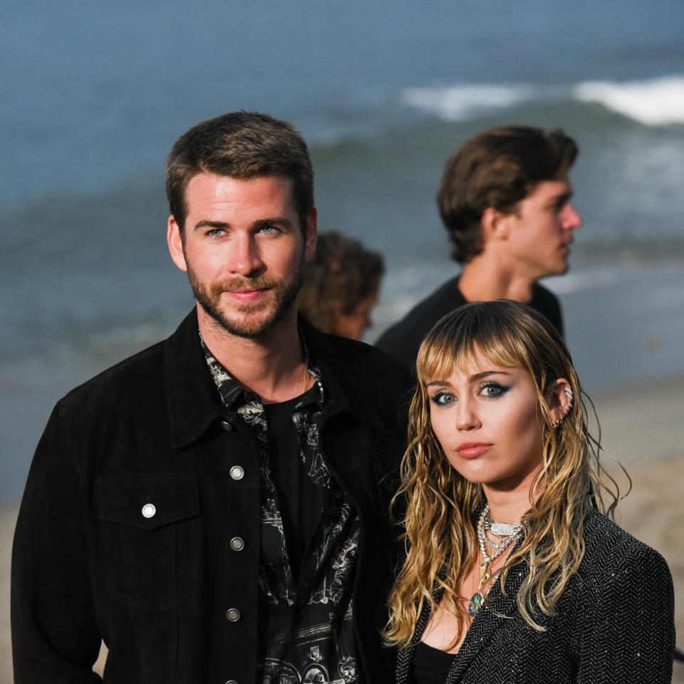 Liam Hemsworth and Miley Cyrus at Saint Laurent mens spring summer 20 show on June 06, 2019 in Malibu, California. (Photo by Presley Ann/WireImage,)