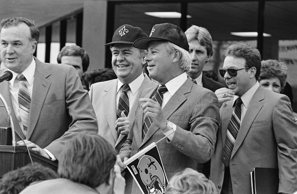 FILE - In this March 13, 1985 file photo, Tom Benson, left, and Louisiana Gov. Edwin Edwards smile as they announce that Benson just signed a deal purchasing the New Orleans Saints for $64 million at a press conference in New Orleans. Edwards, the high-living four-term governor whose three-decade dominance of Louisiana politics was all but overshadowed by scandal and an eight-year federal prison stretch, died Monday, July 12, 2021, of respiratory problems. He was 93. (AP Photo/Bill Haber, File)