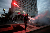 <p>A protester throws a flare at a protest march during the G7 Summit in Quebec City, Quebec, Canada, June 7, 2018. (Photo: Chris Wattie/Reuters) </p>