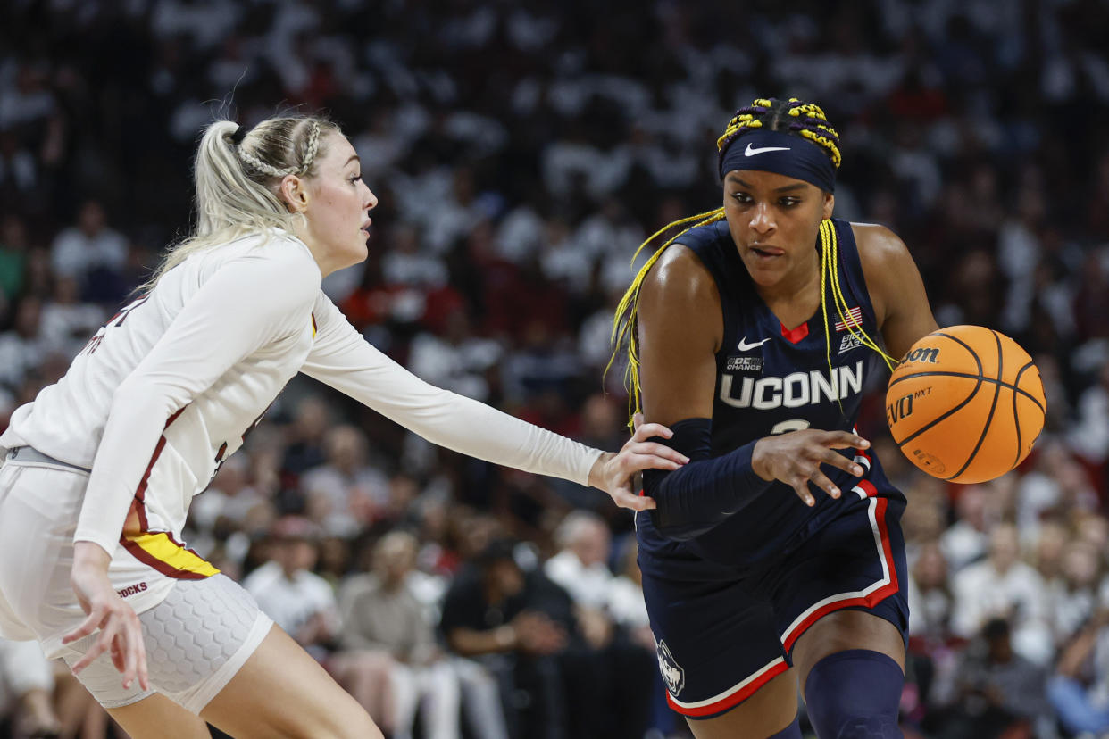 UConn forward Aaliyah Edwards, right, drives against South Carolina forward Chloe Kitts during the second half of an NCAA college basketball game in Columbia, S.C., Sunday, Feb. 11, 2024. (AP Photo/Nell Redmond)