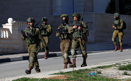 Israeli soldiers walk during a raid near Ramallah, in the Israeli-occupied West Bank December 15, 2018. REUTERS/Mohamad Torokman