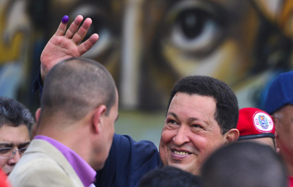 Venezuelan President Hugo Chavez waves to supporters in Caracas on October 07, 2012. Venezuelans voted Sunday with President Hugo Chavez's 14-year socialist revolution on the line as the leftist leader faced youthful rival Henrique Capriles in his toughest electoral challenge yet. AFP PHOTO/Luis Acosta        (Photo credit should read LUIS ACOSTA/AFP/GettyImages)