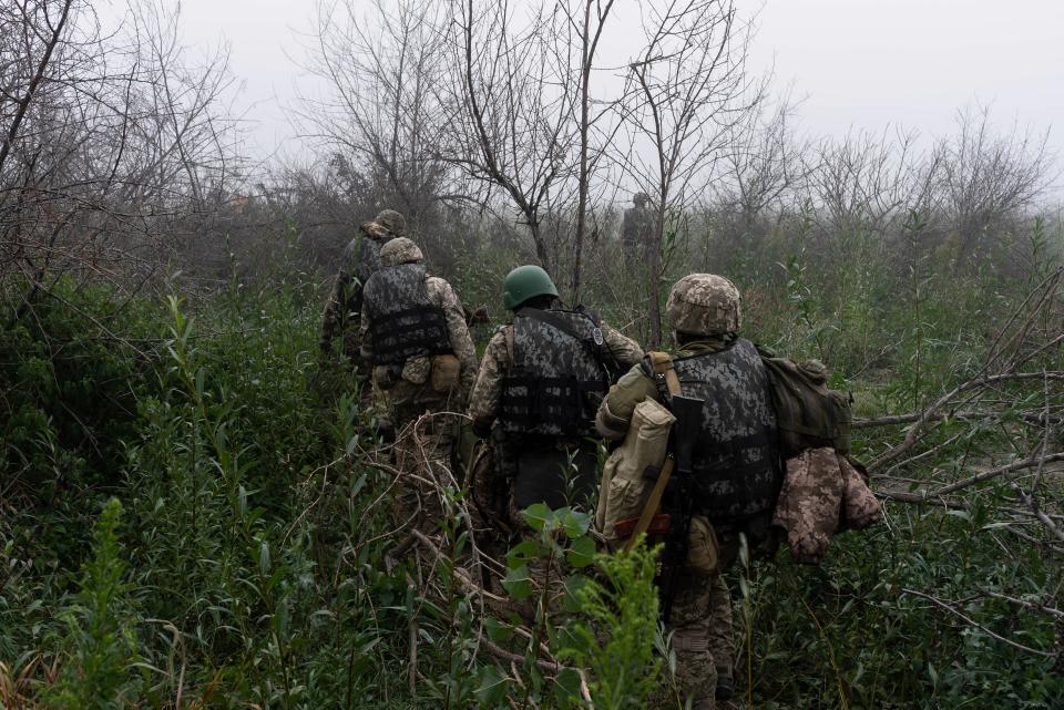 Ukrainian marines move through trees at the frontline close to the Dnipro river near Kherson last week (Copyright 2023 The Associated Press. All rights reserved.)