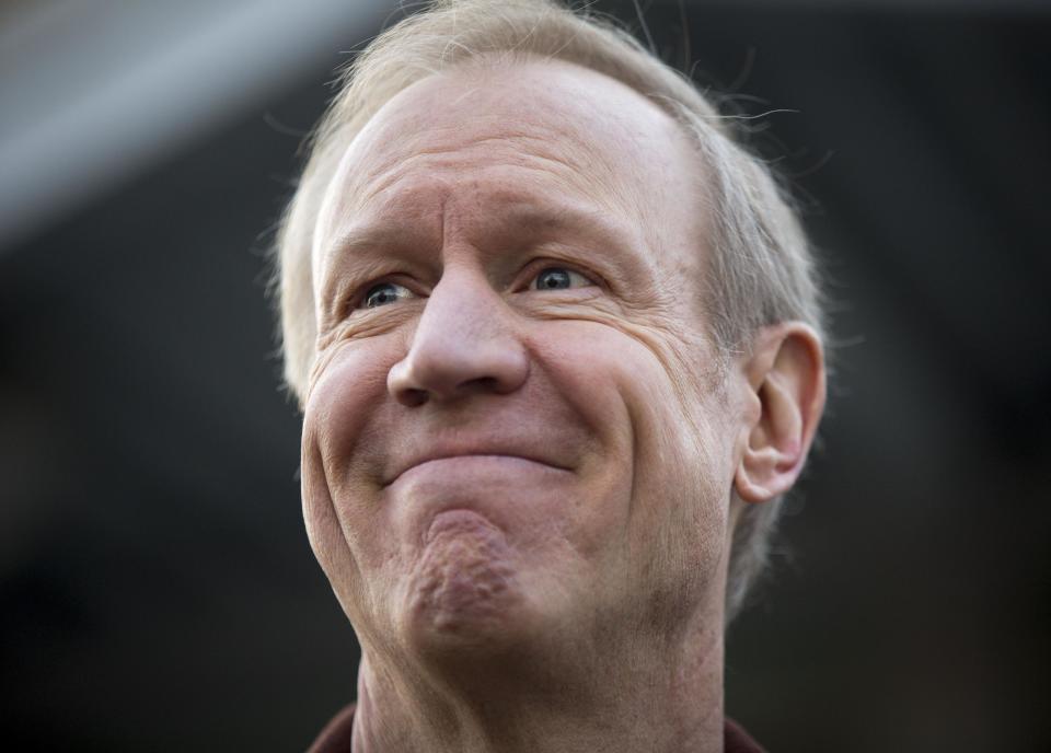 Illinois Republican gubernatorial candidate Bruce Rauner answers questions after voting on Tuesday, March 18, 2014, in Winnetka, Ill. Rauner faces State Sen. Bill Brady, State Sen. Kirk Dillard and State Treasurer Dan Rutherford in the primary election. (AP Photo/Andrew A. Nelles)