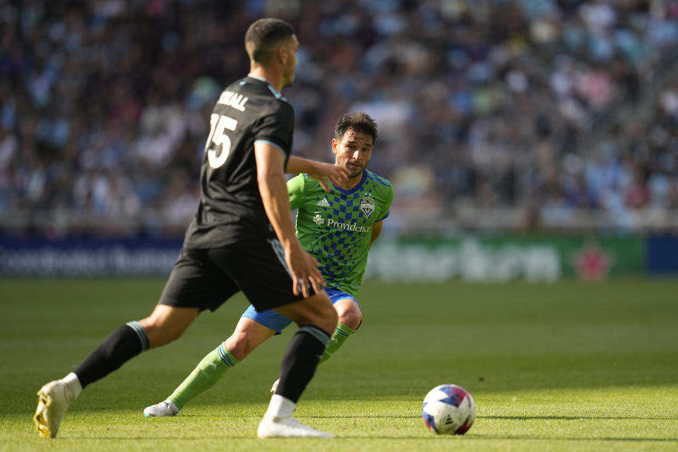 Minnesota United defender Michael Boxall, left, controls the ball as Seattle Sounders midfielder Nicolás Lodeiro defends during the second half of an MLS soccer match, Sunday, Aug. 27, 2023, in St. Paul, Minn. (AP Photo/Abbie Parr)