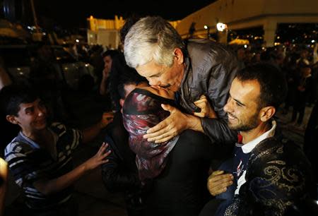 One of the nine newly released Lebanese hostages, who were held by rebels in northern Syria, kisses his wife upon his arrival at Beirut international airport, October 19, 2013. REUTERS/Mohamed Azakir