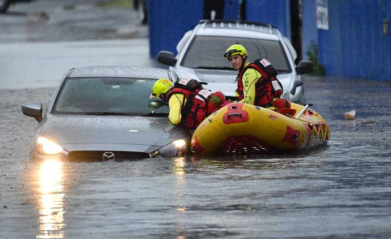 A Swift Water Rescue team from the Queensland Fire and Emergency Services are seen searching flooded cars on Longlands Street at Woolloongabba in Brisbane.