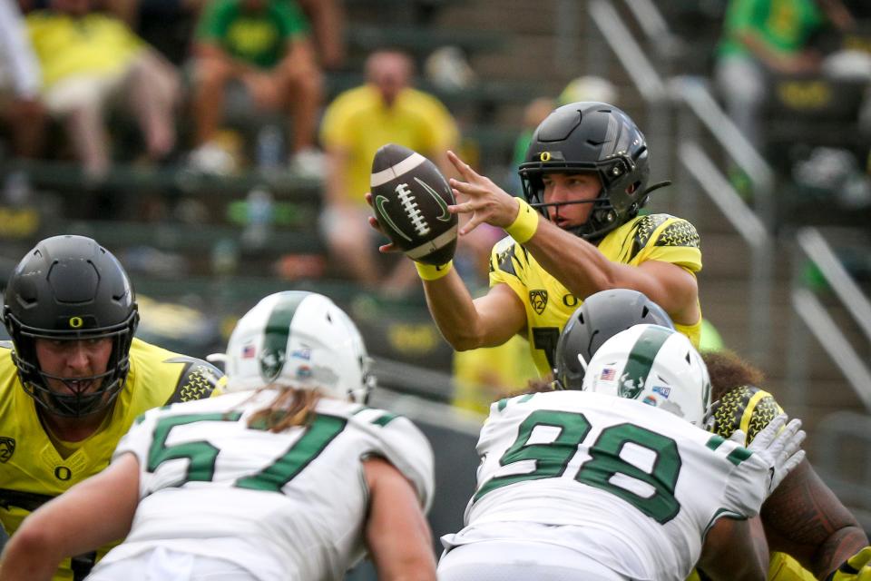 Oregon quarterback Autin Novosad takes a snap as the Oregon Ducks host Portland State in the Ducks’ season opener Saturday, Sept. 2, 2023, at Autzen Stadium in Eugene, Ore.