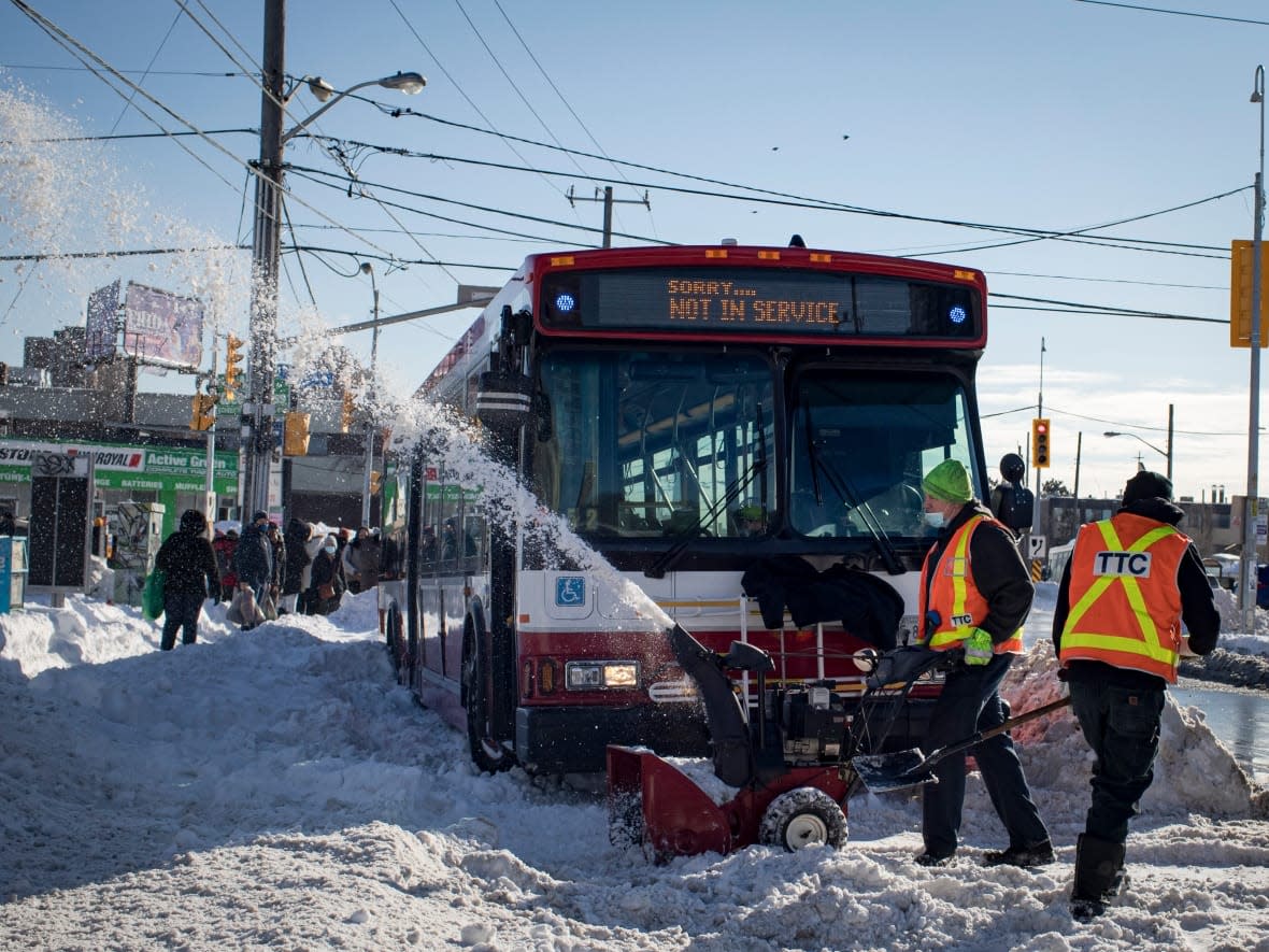 Torontonians dig out on Tuesday, the day after a major snowstorm in Southern Ontario.  At the height of the storm yesterday, some 500 TTC buses had been caught in the snow. (Evan Mitsui/CBC - image credit)