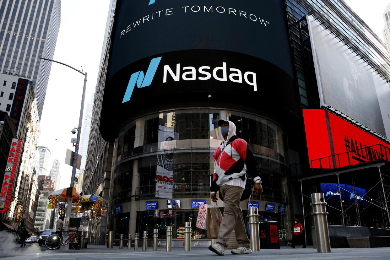 NEW YORK, NEW YORK - MARCH 10: A man walks in front Nasdaq building at Times Square on March 10, 2021, in New York. The Nasdaq Composite continued falling more than half a percent during the day. Also, the move away from Apple Inc, Amazon.com Inc , Facebook Inc, Tesla Inc and Microsoft Corp, falling during the day, helped small-cap stocks rise more than double the gains of the S&P 500. (Photo by John Smith/VIEWpress)