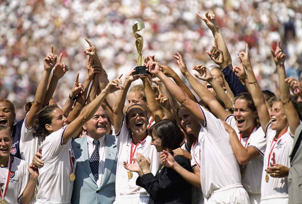 USWNT captain Carla Overbeck raises the 1999 World Cup Trophy as the team celebrates winning the FIFA Women's World Cup on July 10, 1999. (Photo by Harry How/Getty Images)