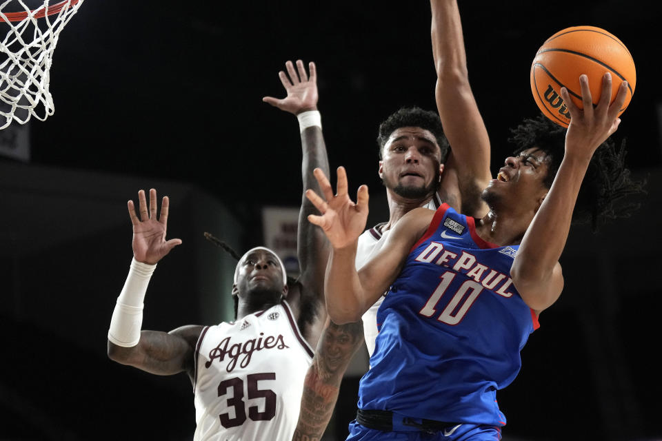 DePaul guard Jaden Henley (10) shoots past Texas A&M guard's Jace Carter, back, and Manny Obaseki (35) during the second half of an NCAA college basketball game Wednesday, Dec. 6, 2023, in College Station, Texas. (AP Photo/Sam Craft)