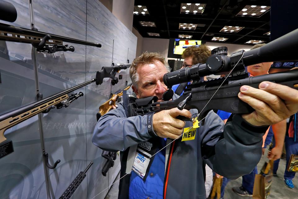 John Jackson, from Fishers, tries firearms at the Smith & Wesson high performance area during the 2019 NRA convention exhibits at the Indiana Convention Center, Friday, April 26, 2019.