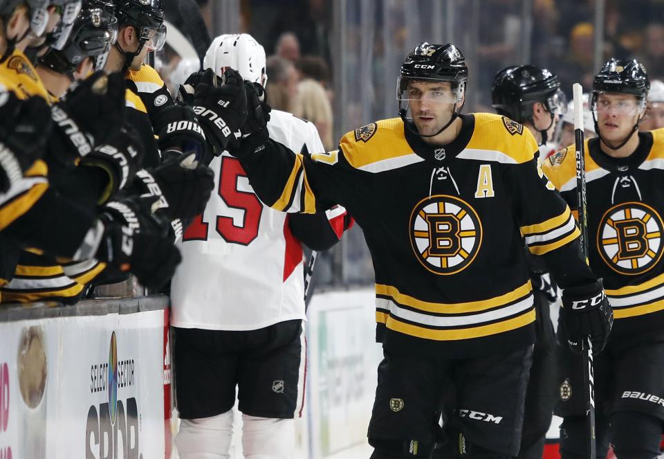 <p>
              Boston Bruins' Patrice Bergeron is congratulated at the bench after scoring against the Ottawa Senators during the first period of an NHL hockey game Monday, Oct. 8, 2018, in Boston. (AP Photo/Winslow Townson)
            </p>