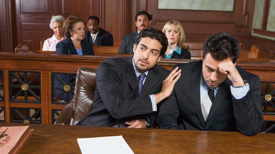 Two men sitting in court.