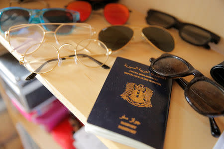 The passport of Syrian migrant Haidar Darwish lies on a shelf in his flat in Berlin, Germany, July 13, 2018. REUTERS/Alessia Cocca