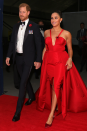 <p>Meghan Markle's most recent red carpet look is one for the ages. At last night's 2021 Salute To Freedom Gala in New York City, the Duke and Duchess of Sussex worth both in attendance, with Meghan wearing a breathtaking ruby red evening gown designed by Carolina Herrera. </p><p>The dress in question features a plunging neckline, thin straps, a fitted bodice and thigh-high split, making it a slightly bolder royal look than the kind we're used to seeing. Megan teamed the dress with matching red satin pumps, silver jewellery ad winged eyeliner. Notably, both Harry and Meghan wore poppy pins in honour of Remembrance Day.</p>