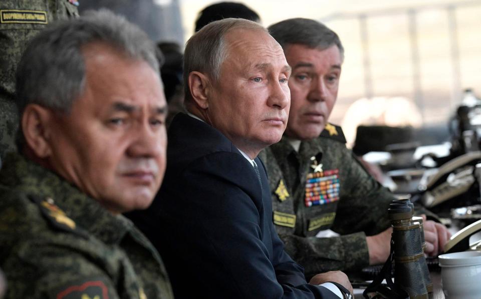 Russian President Vladimir Putin, center, Russian Defense Minister Sergei Shoigu, left, and Head of the General Staff of the Armed Forces of Russia and First Deputy Defense Minister Valery Gerasimov watch a military exercises on training ground "Telemba", about 80 kilometers (50 miles ) north of the city of Chita during the military exercises Vostok 2018 in Eastern Siberia, Russia, Thursday, Sept. 13, 2018 - Alexei Nikolsky/ Pool Sputnik Kremlin