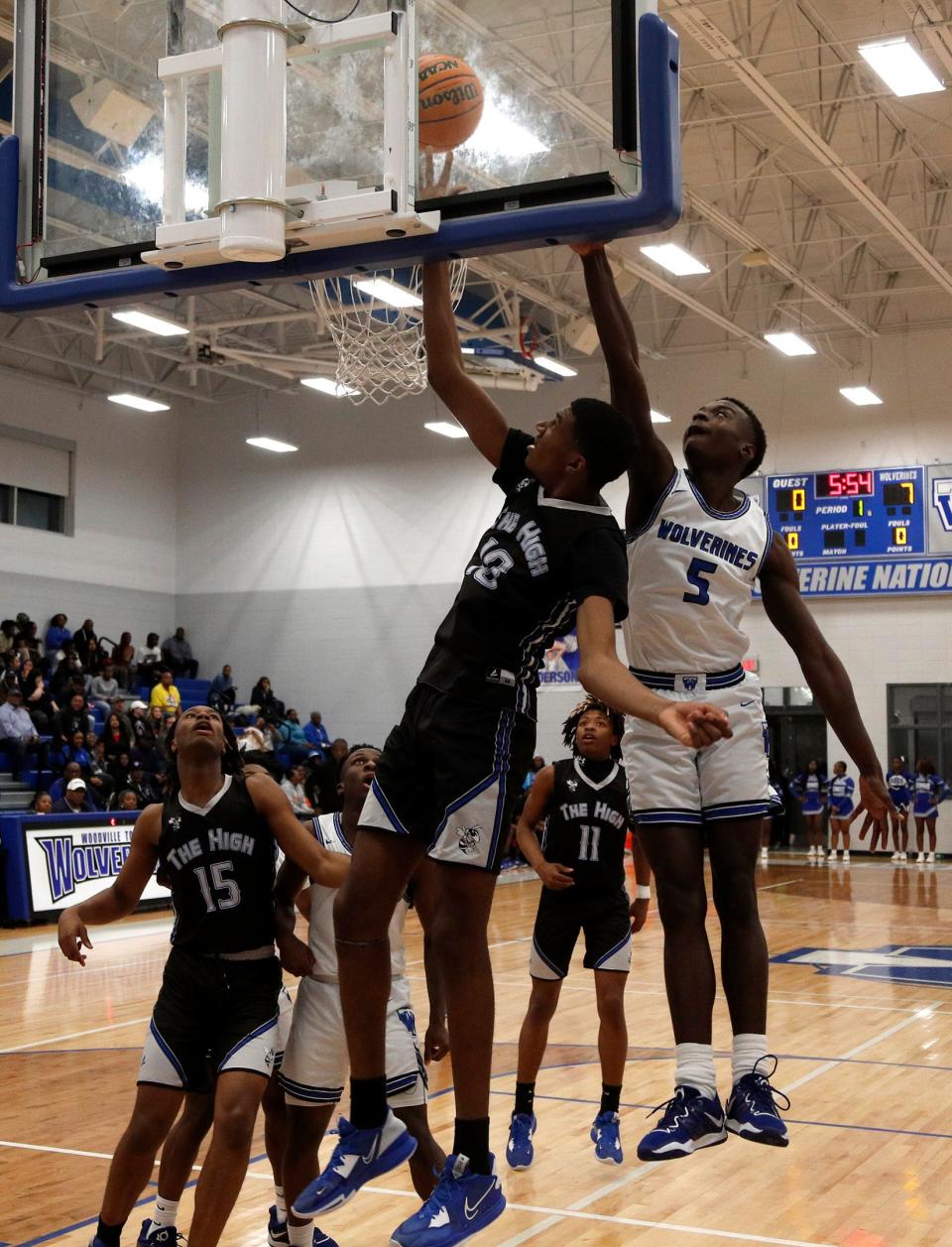 Savannah High's Deshawn Davis attempts a basket under Woodville-Tompkins' Tyler Grant Friday during the Region 3A Div. 1 Title game.