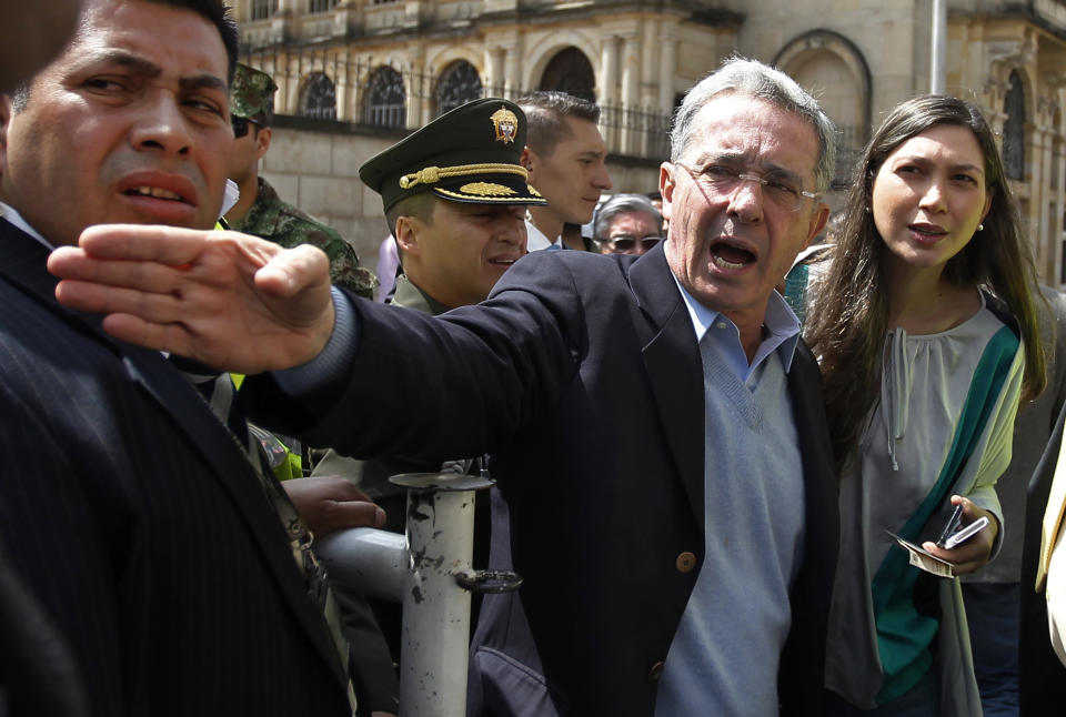Colombia's former President Alvaro Uribe, who is running for Senator for the Democratic Center Party, talks to the press after voting in legislative elections in Bogota, Colombia, Sunday, March 9, 2014. (AP Photo/Fernando Vergara)