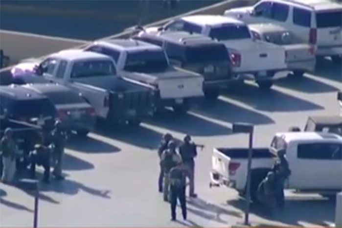Armed officers in the airport carpark. Image: 7 News