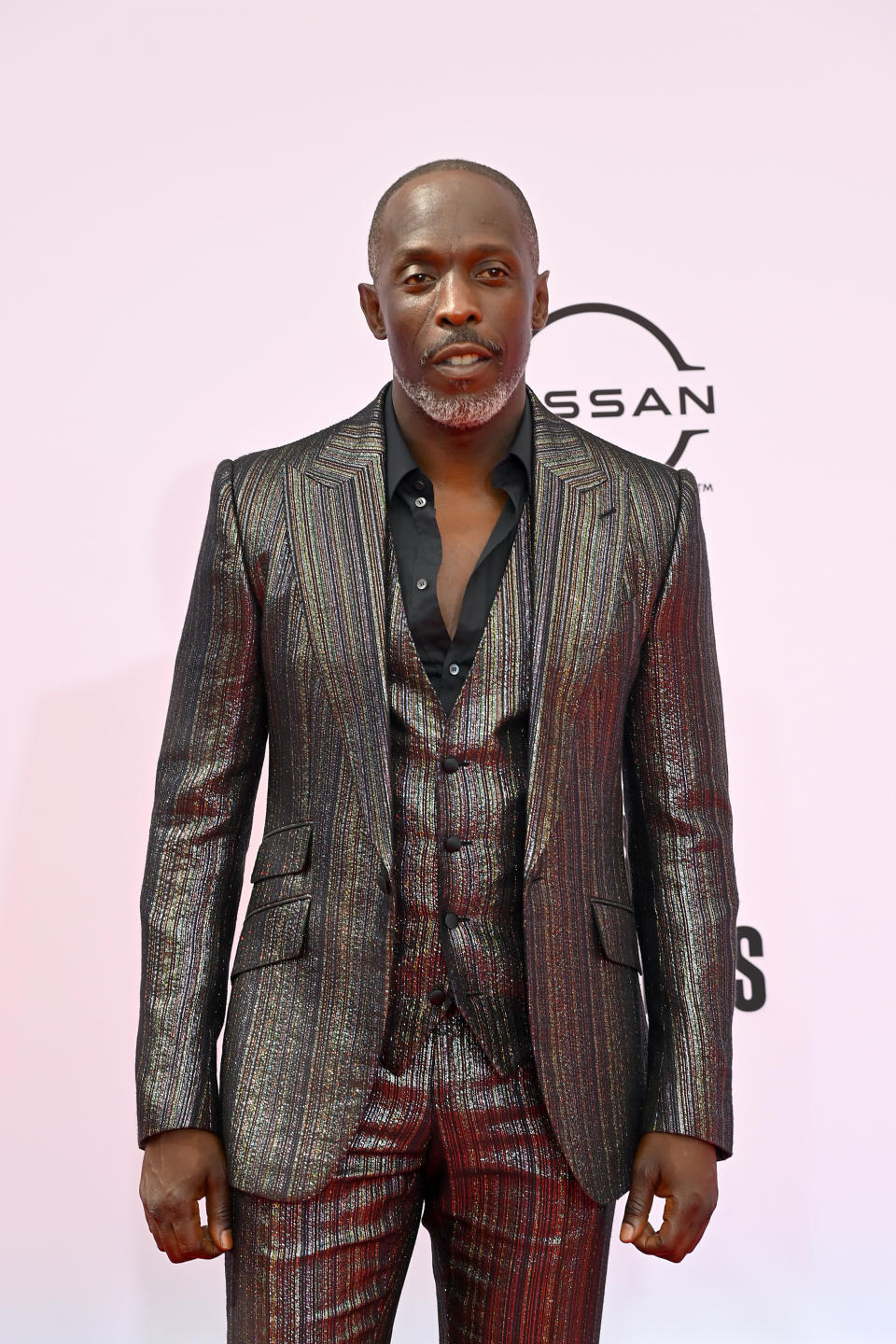 Michael in a textured metallic suit at a red carpet event