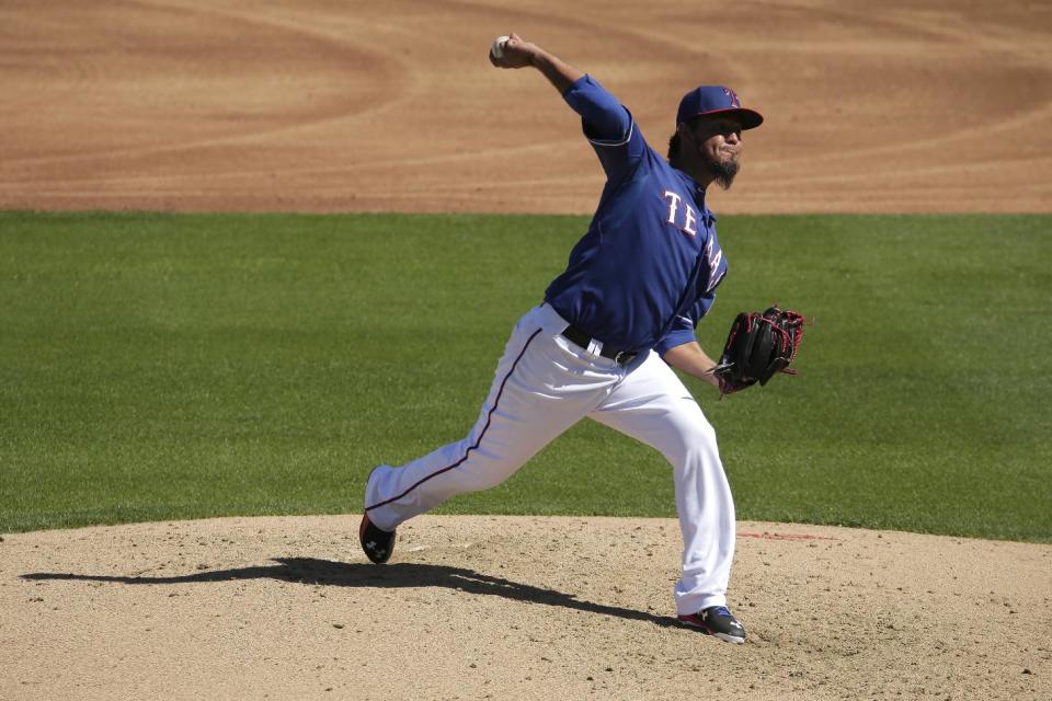 Texas Rangers relief pitcher Yovani Gallardo throwsduring the third inning of a spring training baseball game against the Kansas City Royals Wednesday, March 4, 2015, in Surprise, Ariz. (AP Photo/Charlie Riedel)