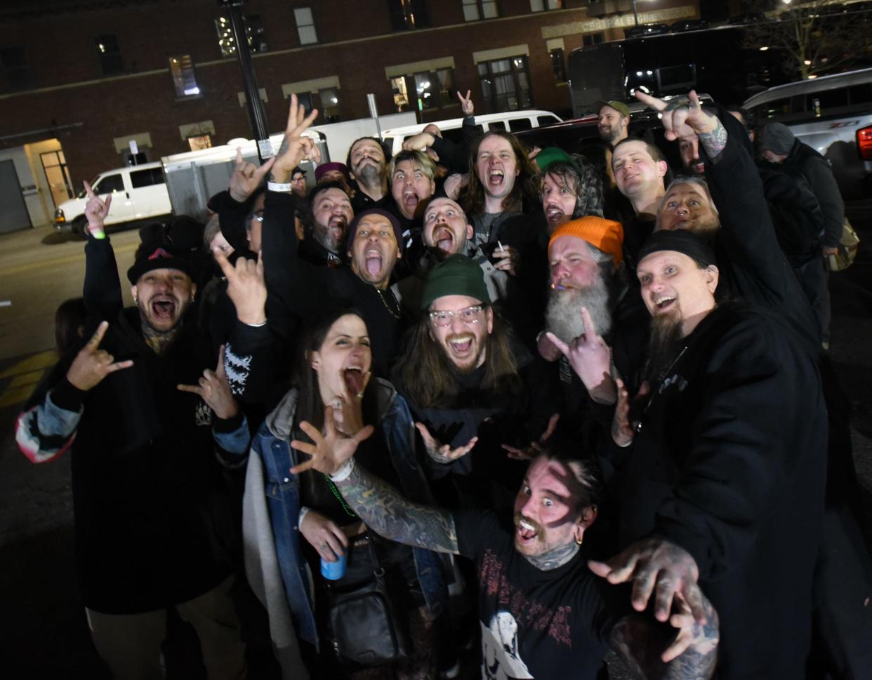 Grammy award-winning bluegrass musician Billy Strings, right, poses for a picture with friends, fans, and fellow musicians after his guest appearance Sunday, March 18, 2024, with former Lansing heavy metal/metalcore band Flesh and Blood Robot at the Pyramid Scheme in Grand Rapids. Strings was a fan of the hardcore heavy metal band as a teenager, and asked the band if he could join them onstage for their reunion show.