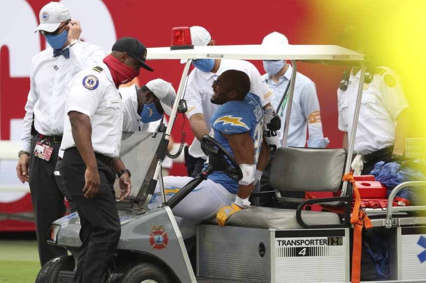 Los Angeles Chargers running back Austin Ekeler (30) is carted off the field after getting hurt.