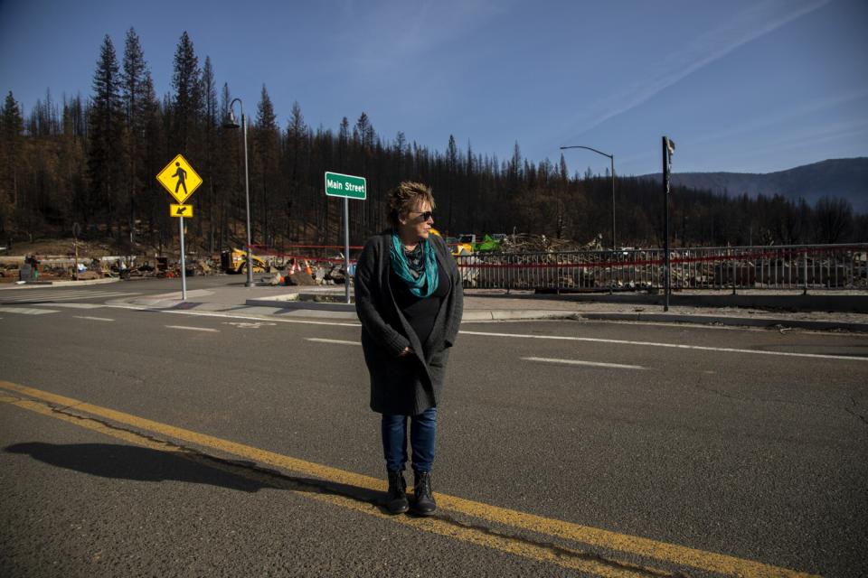 Sue Weber stands near a Main Street sign in Greenville.