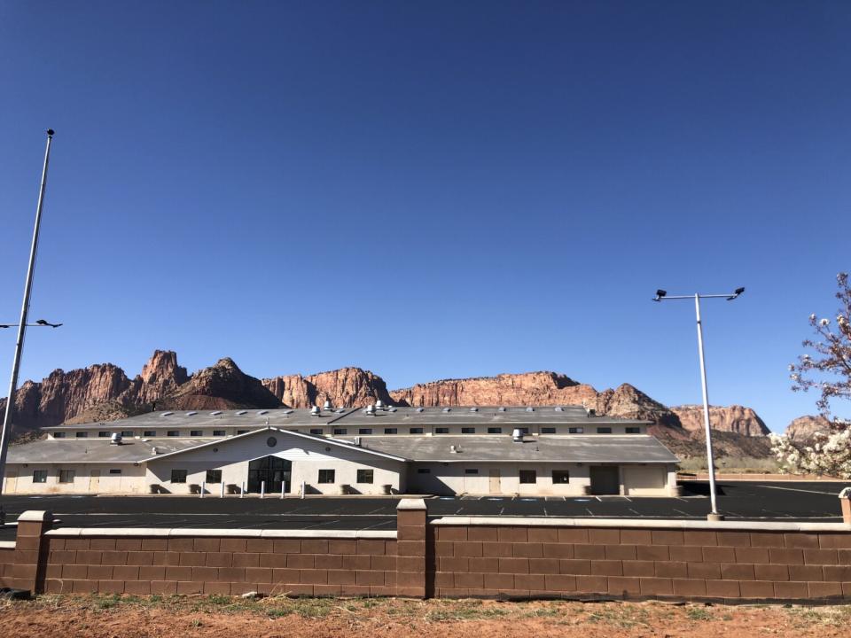 A house beyond a brick wall