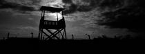 An observation tower stands inside the former Nazi death camp of Auschwitz Birkenau or Auschwitz II in Oswiecim, Poland, Sunday, Dec. 8, 2019. On Jan. 27, 1945, the Soviet Red Army liberated the Auschwitz death camp in German-occupied Poland. Auschwitz was the largest of the Germans' extermination and death camps and has become a symbol for the terror of the Holocaust. In advance of that, Associated Press photographer Markus Schreiber visited the site. Using a panoramic camera with analog film, he documented the remains of the camp in a series of haunting black and white photos. (AP Photo/Markus Schreiber)