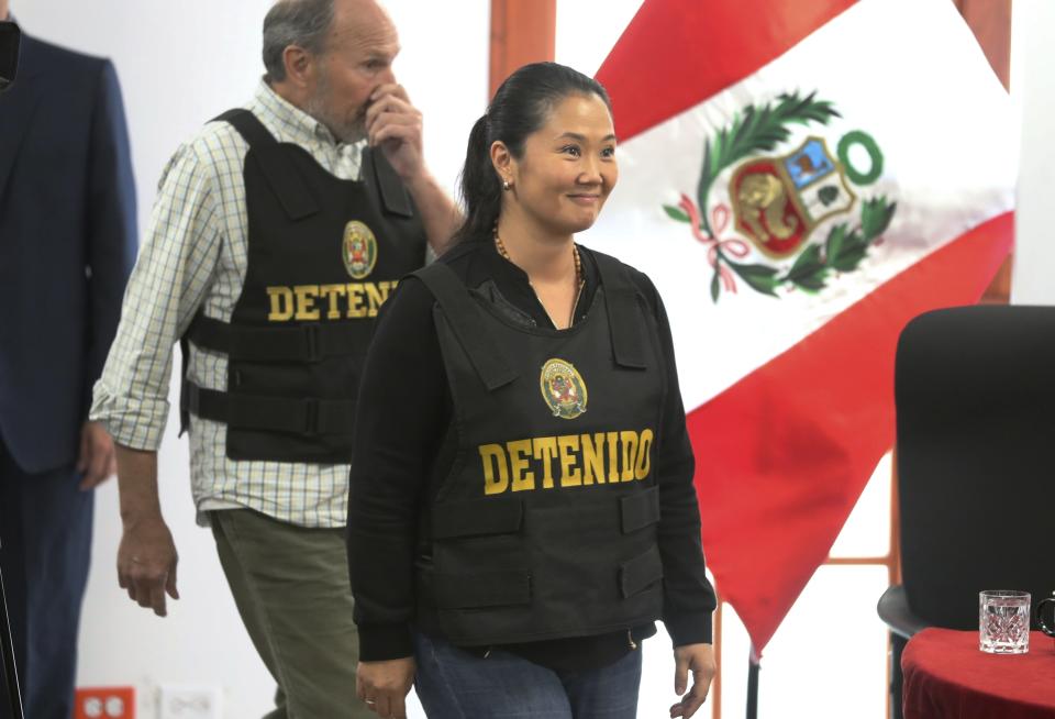 FILE - In this Oct. 17, 2018 file photo, Keiko Fujimori, the daughter of Peru's former President Alberto Fujimori, and leader of the opposition party, enters to the courtroom wearing a chest vest that reads in Spanish: "Detained" during a hearing where she is appealing her detention as part of a money-laundering investigation in Lima, Peru. Keiko Fujimori's detention marked the start of a new downfall for both the party and the woman who a few short years before was on the verge of the presidency. (AP Photo/Martin Mejia, File)