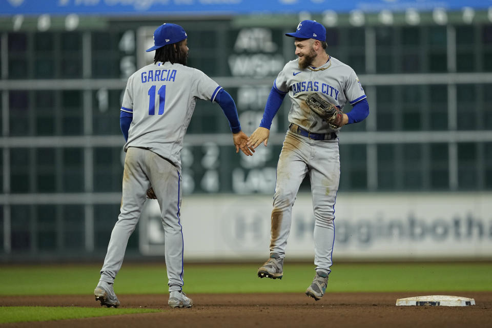 Kansas City Royals' Maikel Garcia (11) and Kyle Isbel celebrate after a baseball game against the Houston Astros Friday, Sept. 22, 2023, in Houston. The Royals won 7-5. (AP Photo/David J. Phillip)