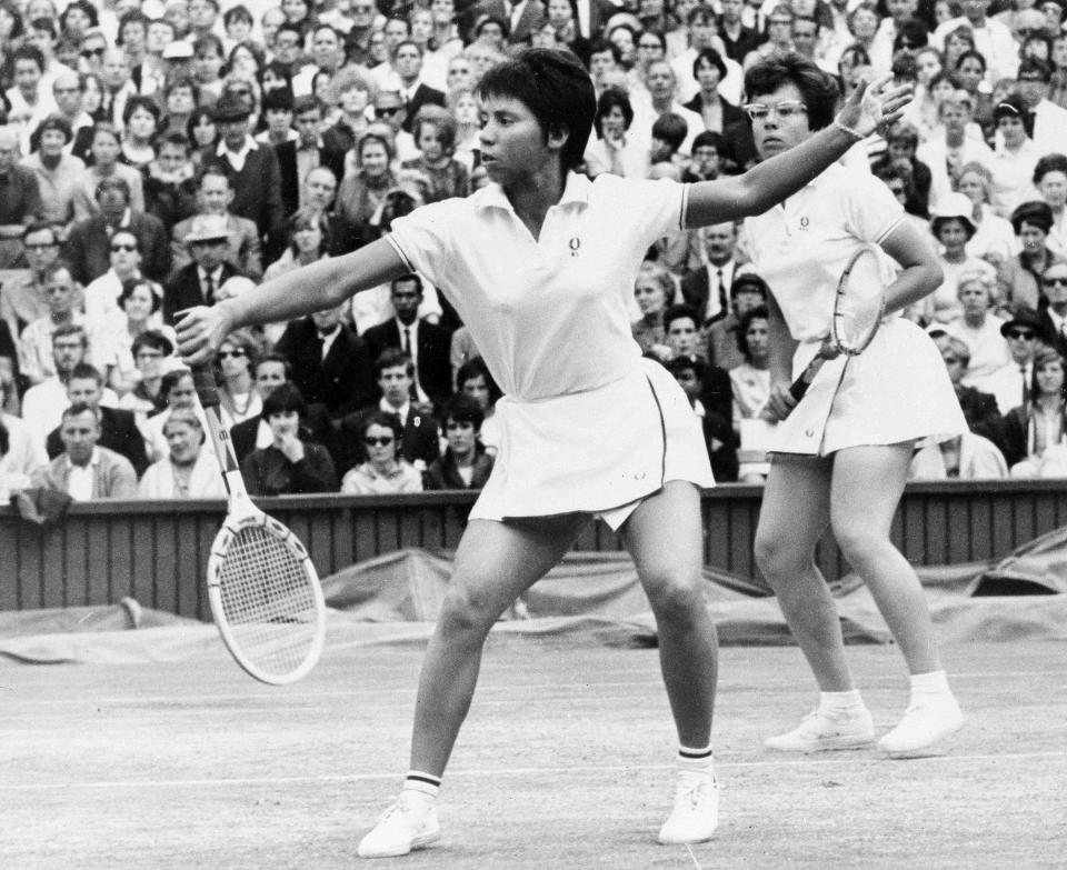 FILE - Rosemary Casals of San Francisco makes a return as partner, Billie Jean King of Long Beach, Calif., watches July 8, 1967, in the Women's Doubles title match at Wimbledon. A half-century later, Billie Jean King thinks back on the landmark gathering of female tennis players at a London hotel, June 21, 1973, shortly before they competed at Wimbledon and acknowledges she wasn’t sure how things would go that day.(AP Photo/File)
